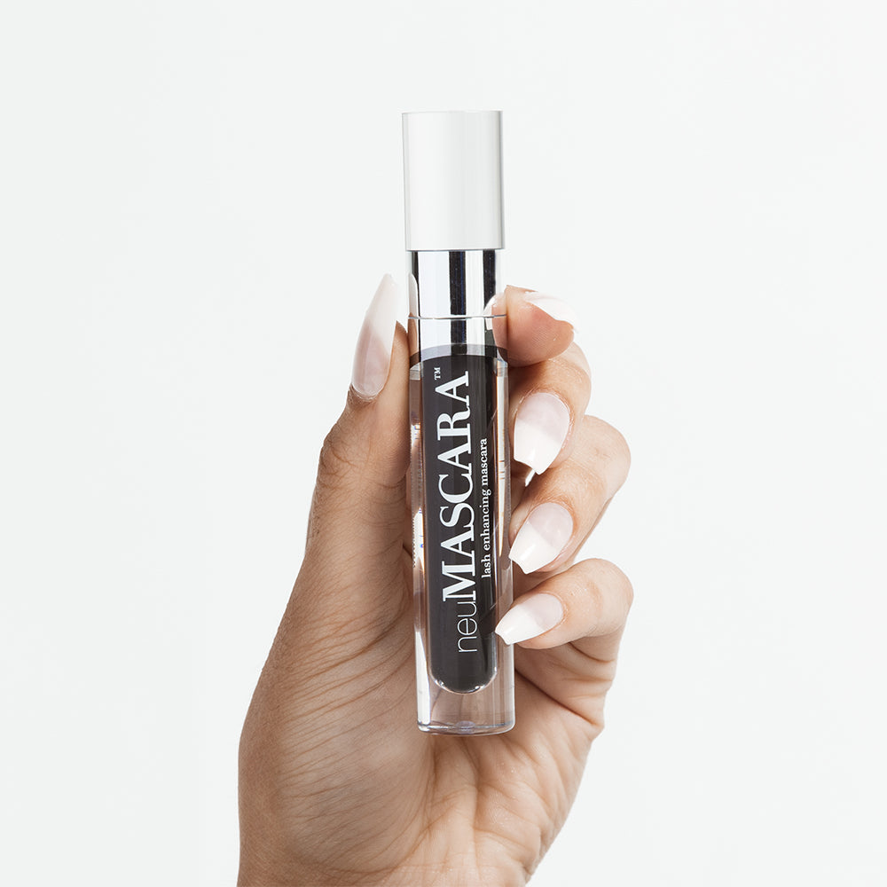 neuMASCARA™ product held up by model&#39;s hand