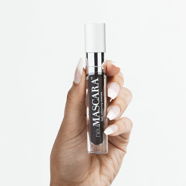 neuMASCARA™ product held up by model's hand