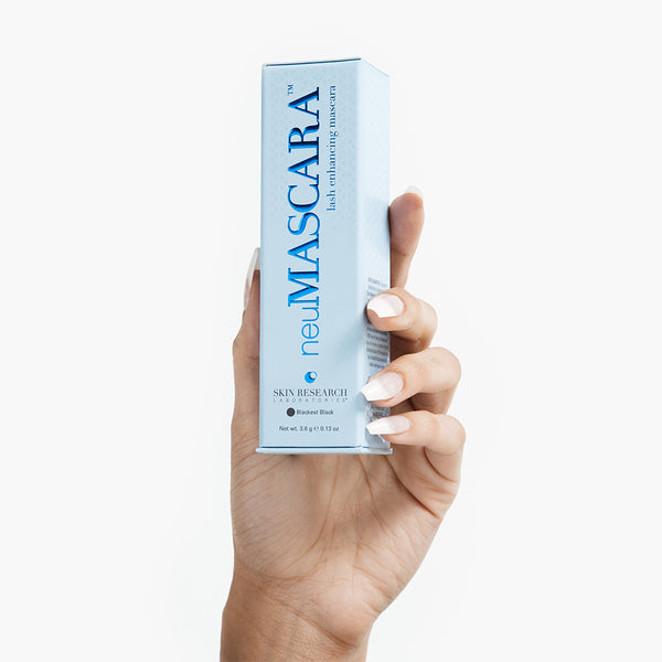 neuMASCARA™ packaging box held up by model's hand